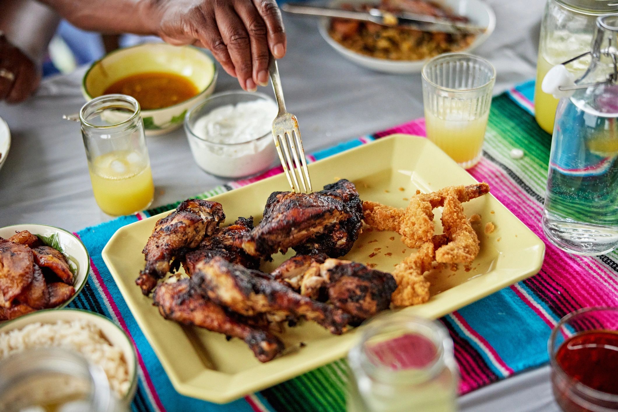 Jamaican jerk chicken party tray with Caribbean sides