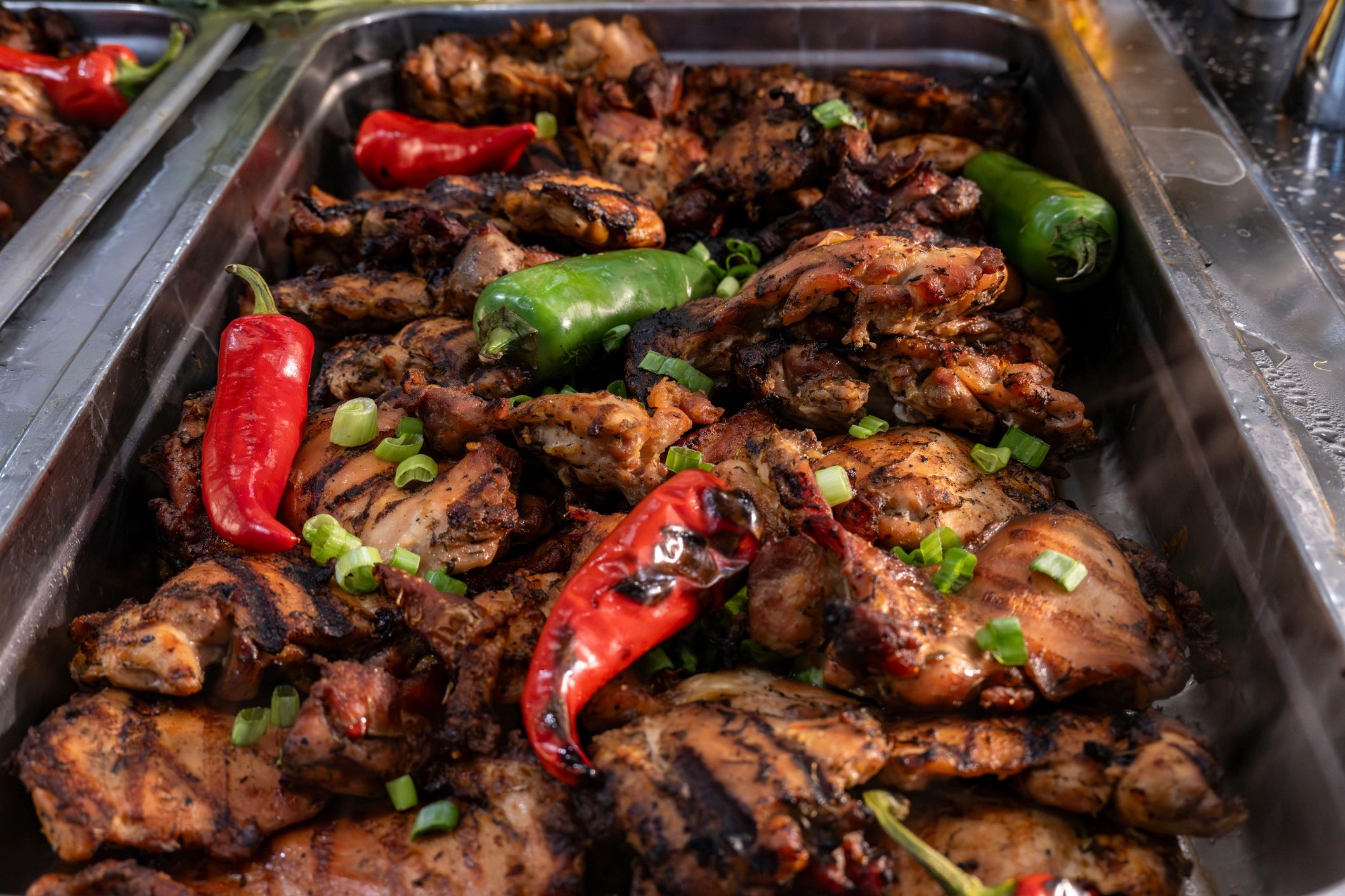 Jamaican jerk chicken party tray with Caribbean sides
